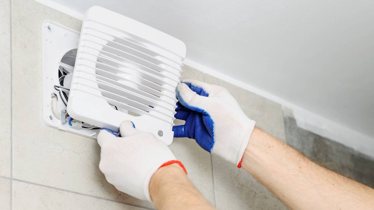 Installation,Of,Household,Appliances.,Workman,Fixing,The,Exhaust,Fan,On